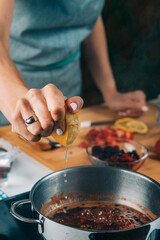Woman Cooking Fruits and Making Homemade Jam.