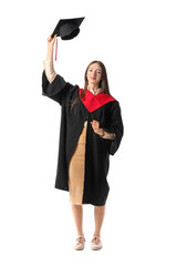 Happy female graduating student on white background