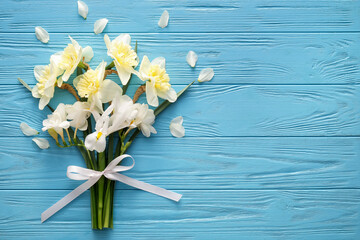 Bouquet of beautiful flowers on color wooden background