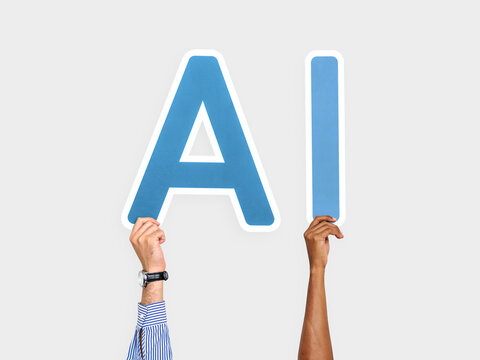 Hands holding up blue letters forming the abbreviation AI - Powered by Adobe