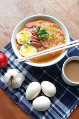 Photo of noodle soup with toppings such as sausages, eggs, and vegetables