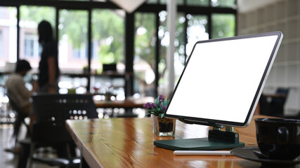 Mock up computer with empty screen on wooden table at creative office.