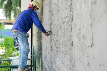 Plasterers using trowels mason for plastering and leveling mortar concrete on the brick wall at the...