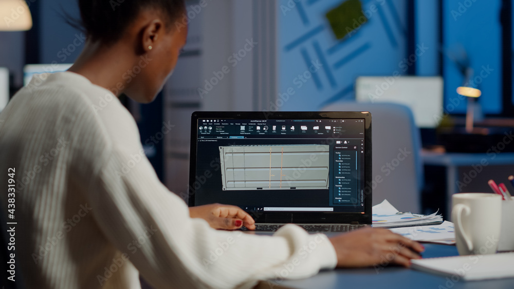 Poster black freelancer architect working in 3d software to elaborate container design sitting at desk in b