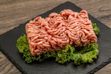Raw pork minced meat over board