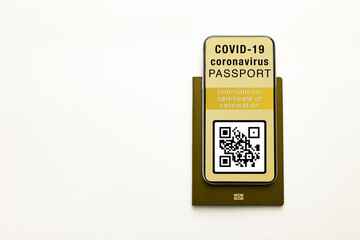 Modern Smartphone displaying a valid digital vaccination certificate for COVID-19 with copy space for text. Vaccination, disease immunity passport, health concepts. .