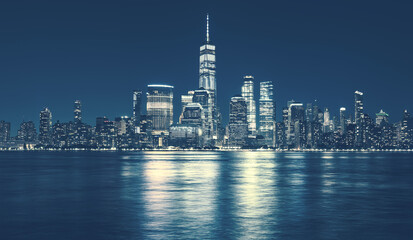 Manhattan skyline at night, blue color toned, New York City, USA.