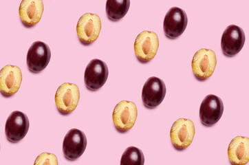 Fresh ripe plums on color background