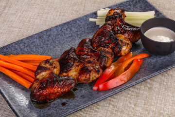Grilled chicken wings with vegetables
