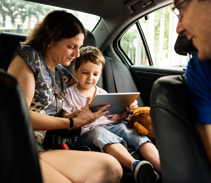 Son and Mom Using Tablet on the Car