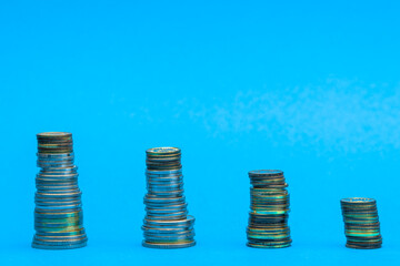 Money stacks. Coins descending in columns. Concept of recession and financial crisis. Coronavirus...