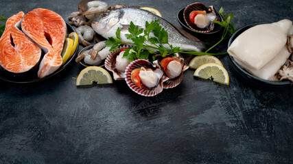 Seafood variety on dark background. Healthy diet eating concept.