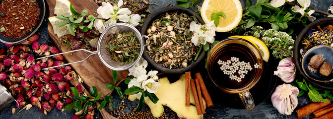 Obraz na płótnie Canvas Various kinds of herbal tea on dark background. Natural herbs medicine.