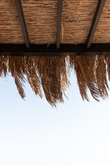 Lounge pavilion for relax with tent made of dry palm leaves. Luxury summer vacation in tropical paradise resort hotel