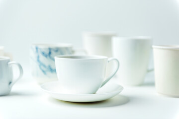 Closeup of coffee cups on white table