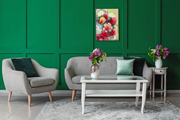 Interior of stylish living room with vases and lilac flowers