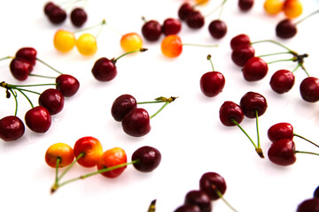 Red and yellow ripe cherries. Summer background of juicy fruits.