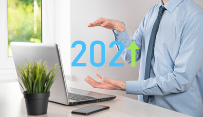 Business development to success and growing growth year 2021 concept.Plan business growth graph in year 2021 concept.Businessman plan and increase of positive indicators in his business.