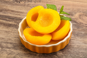 Sweet ripe canned peaches with mint