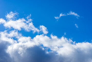 Dramatic blue sky with white clouds background.