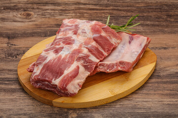 Raw pork ribs served rosemary