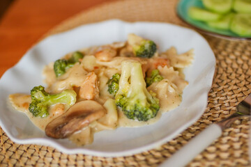 Roasted chicken mushroom pepper pasta in a white plate. toning. selective focus