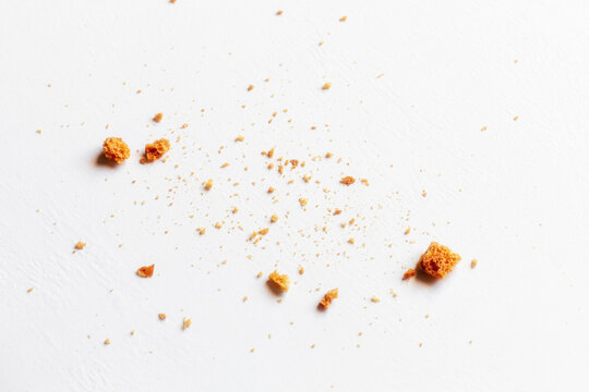 sprinkled white bread crumbs on white plate close up selective focus