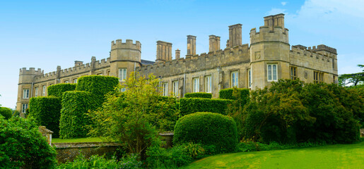 Corby, U.K., 6 May 2021. Dene Park Castle. Old big medieval traditional english castle building with green gardens panorama © Inga