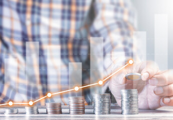 man stacking coins in a hierarchy business growth idea