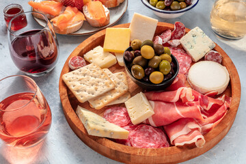Charcuterie and cheese board with wine and olives. Italian antipasti. Blue cheese, parma ham,...