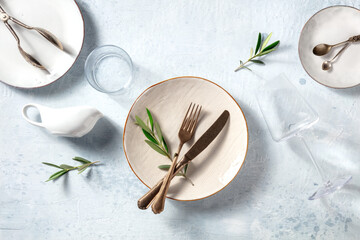 Modern tableware, overhead flat lay shot with olive branches. Mediterranean cuisine restaurant...