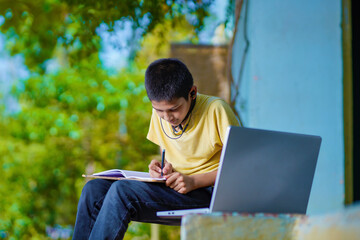 Asian boy using Laptop computer for online study homeschooling during home quarantine. homeschooling, online study, home quarantine, online learning, corona virus or education technology concept