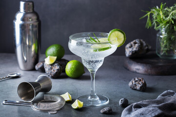 Hard seltzer cocktail with lime, rosemary and bartenders accessories