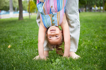 Happy Mother and her daughter playing in the park. Enjoying summer. Happy parenthood