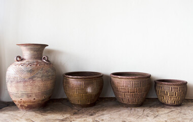 Fototapeta na wymiar Handmade antique pottery by a wall