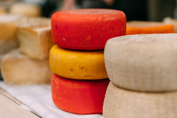 Large ready-made pieces of handmade cheese on the counter