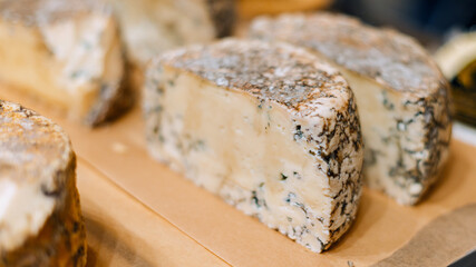 Large ready-made pieces of handmade blue cheese on the counter