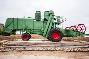 Fototapeta na wymiar Green and red combine harvester, Latvia.
