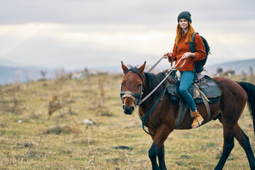 Fototapeta premium woman hiker riding horse travel mountains landscape