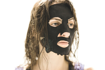 A woman with a skin mask in front of a white background