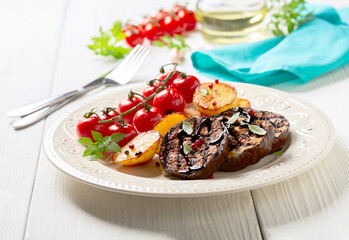 Eggplant steaks with vegetables.
