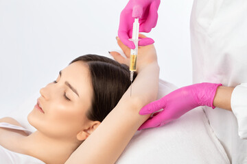 Doctor doing stem cell therapy on a patient's elbow after the injury. Treating knee pain with...