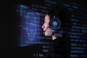 Female programmer scanning her face with biometric security technology on virtual screen digital...