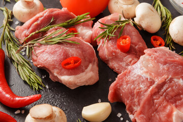 raw meat,  pork  tenderloin with chili pepper, garlic, rosemary