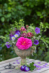Blumenstrauß mit pink Rose und lila Sommerblumen in vintage Vase