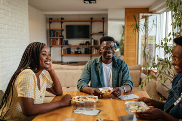 Black friends ordering and eating delivery food