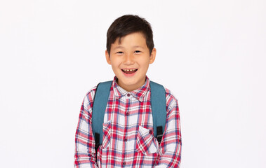 asian cute kid or boy going to school with small school bag, isolated over white background
