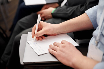 Business people at the conference. Row of business people  listen to the speaker on the forum or at seminar in modern conference room