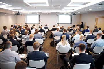 Group of people at the business conference, back view. Row of business people  listen to the speaker on the forum or at seminar in modern conference room. - obrazy, fototapety, plakaty