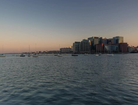 View on East Boston with boats in day to night time lapse